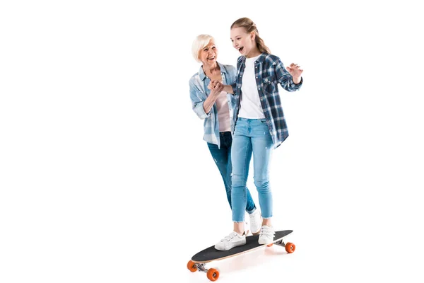 Happy granddaughter with skateboard — Stock Photo