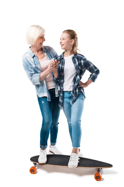 Happy granddaughter with skateboard — Stock Photo