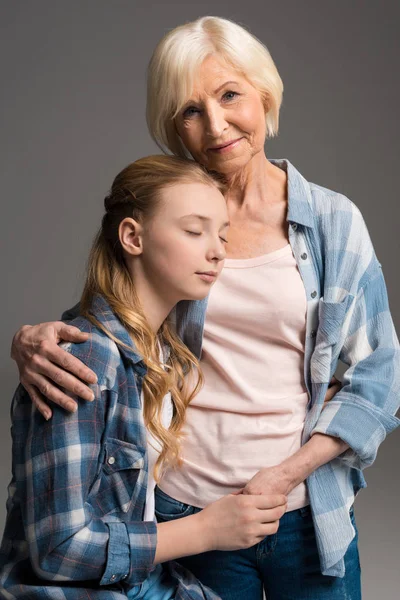 Abuela y nieta abrazándose - foto de stock