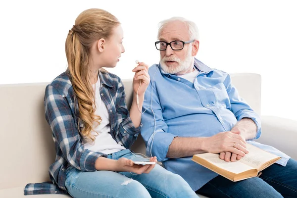 Grandfather and grandchild listening music — Stock Photo
