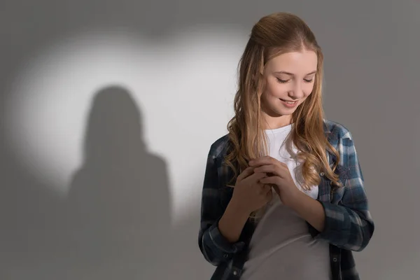 Girl with heart shaped shadow — Stock Photo