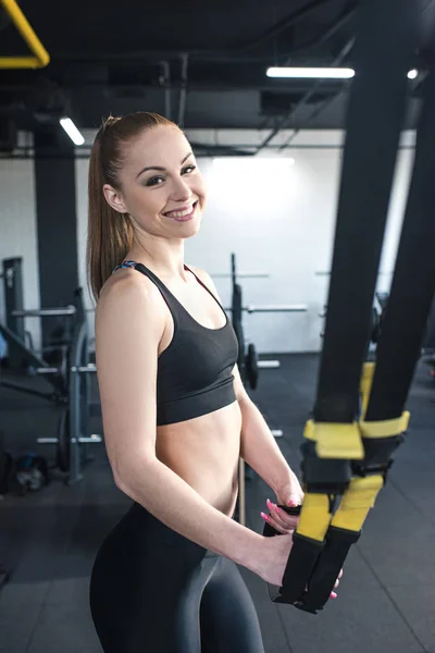 Sportswoman training with trx — Stock Photo