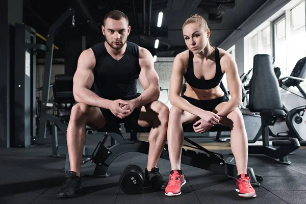 Young couple of athletes training at gym — Stock Photo