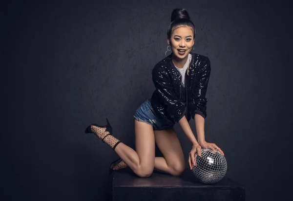 Glamour asian girl with disco ball — Stock Photo