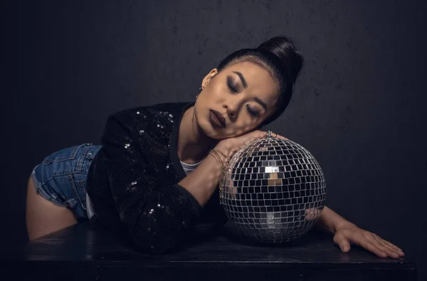 Glamour asian girl with disco ball — Stock Photo