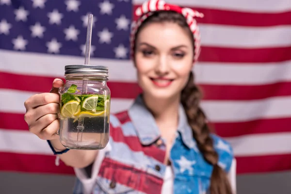 Woman showing drink in hand — Stock Photo