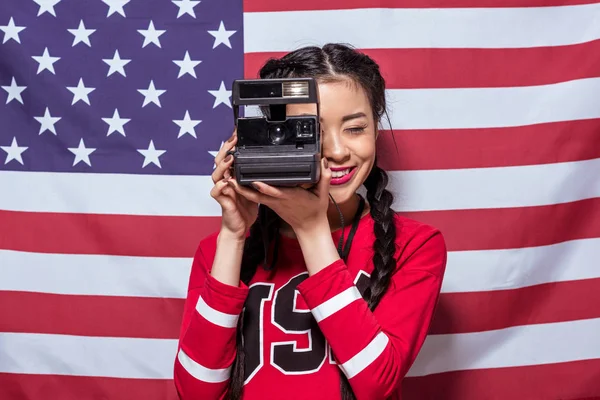 Woman holding retro photo camera — Stock Photo