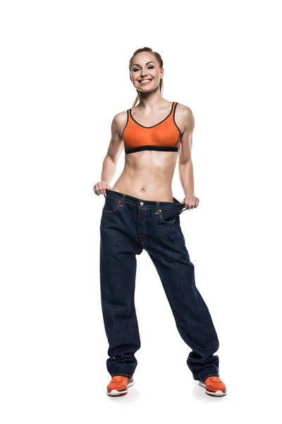 Sportswoman wearing oversized jeans — Stock Photo