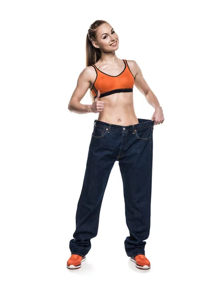 Sportswoman wearing oversized jeans — Stock Photo