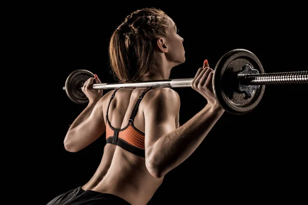 Sportswoman training with barbell — Stock Photo