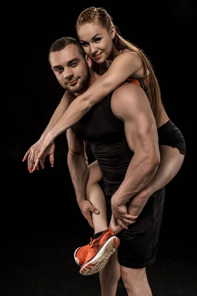 Sportive man holding woman — Stock Photo
