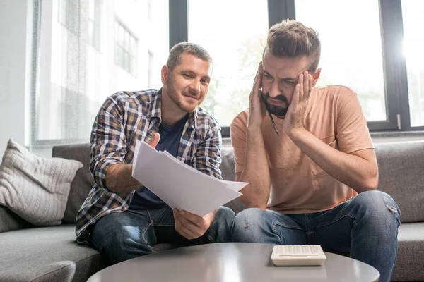 Homosexual couple counting expenses — Stock Photo