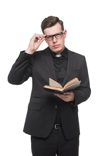 Young priest reading scripture book — Stock Photo