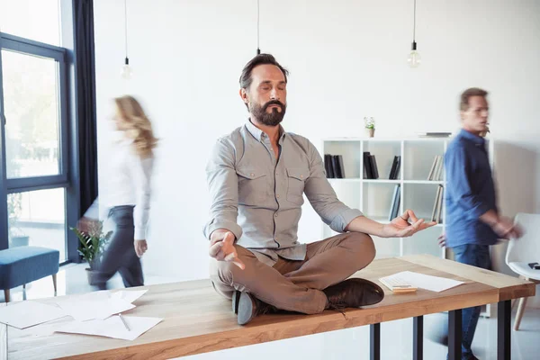 Businessman meditating in office — Stock Photo