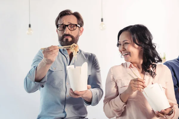 Coworkers eating asian food — Stock Photo