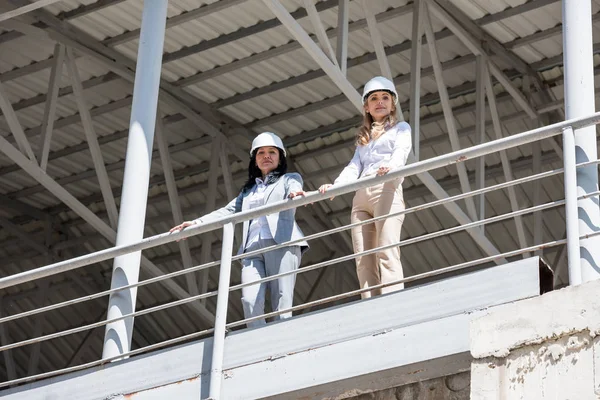 Architects in formal wear standing at construction — Stock Photo