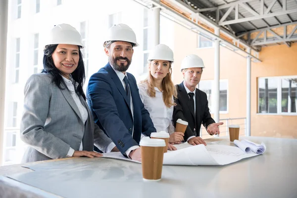 Group of multiethnic architects in suits — Stock Photo