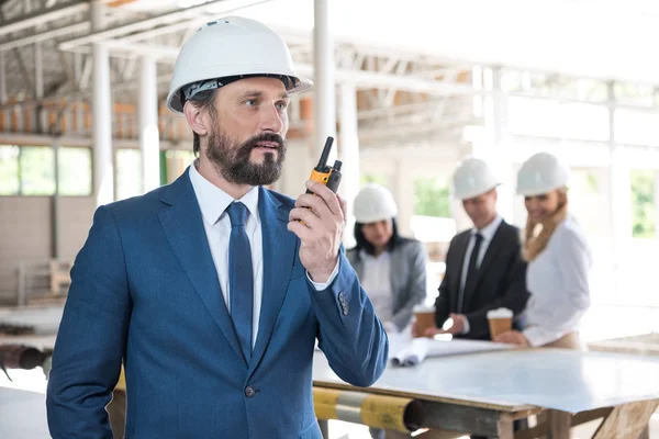 Architect in suit talking on radio set — Stock Photo