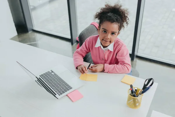 Little girl at office table — Stock Photo