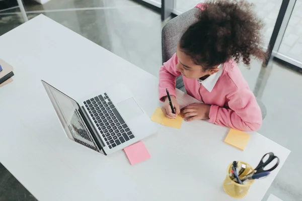 Little girl at office table — Stock Photo