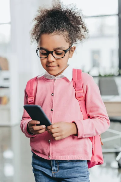 Linda niña con teléfono inteligente - foto de stock