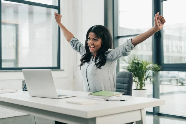 Businesswoman celebrating success at workplace — Stock Photo