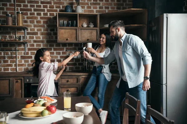 Father and daughter playing in kitchen — Stock Photo