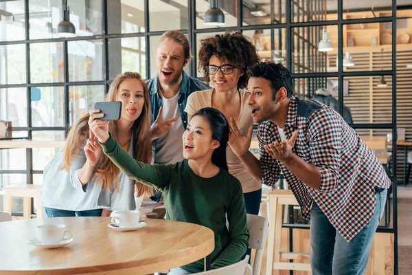 Friends taking selfie in cafe — Stock Photo