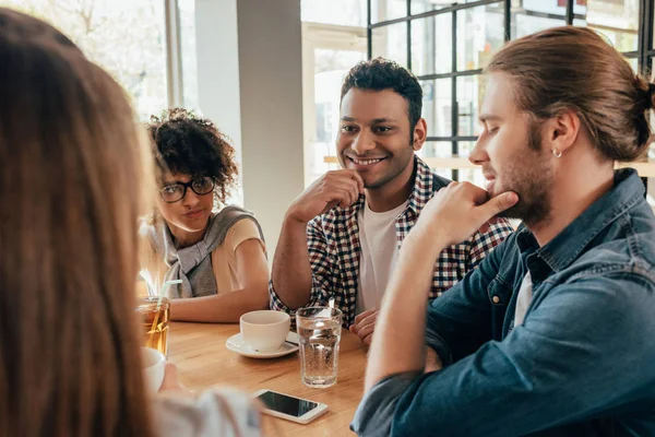 Friends spending time together in cafe — Stock Photo