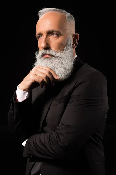 Businessman thoughtfully touching beard — Stock Photo