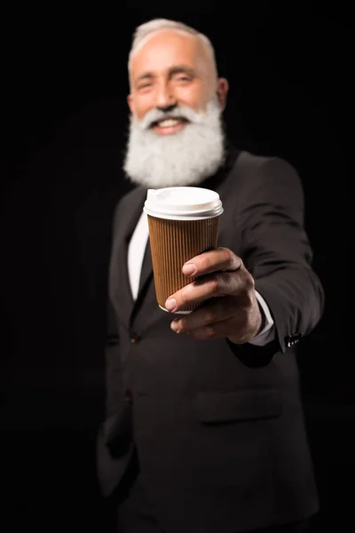 Businessman holding out coffee — Stock Photo