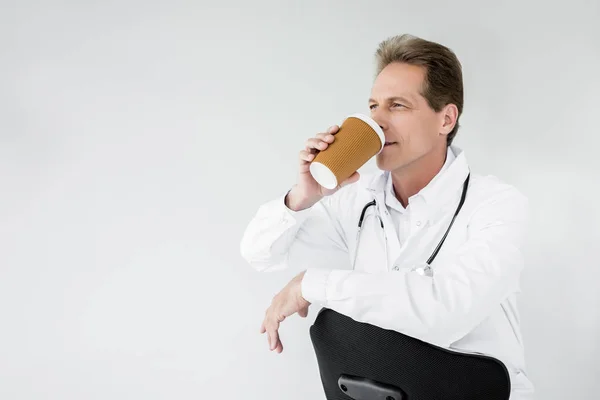 Doctor drinking coffee — Stock Photo