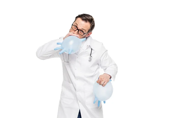 Doctor blowing medical gloves — Stock Photo