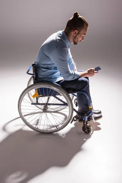 Mann im Rollstuhl nutzt Smartphone — Stockfoto