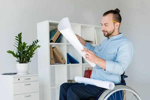 Disabled businessman looking at documents — Stock Photo