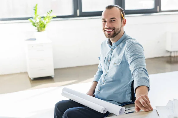 Disabled architect holding blueprints — Stock Photo