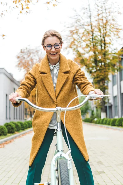 Femme souriante équitation vélo — Photo de stock