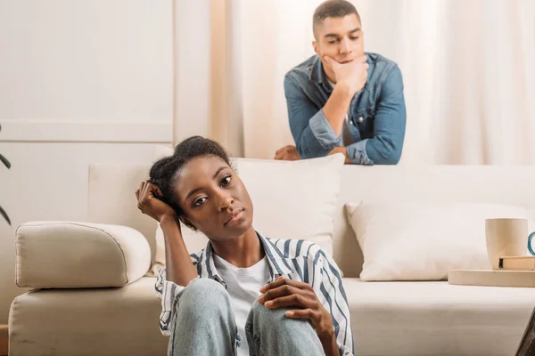 Frustraited couple beside couch — Stock Photo