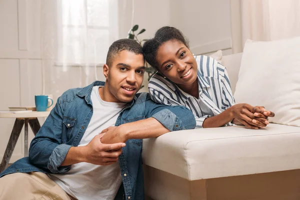 Couple sitting together on sofa — Stock Photo