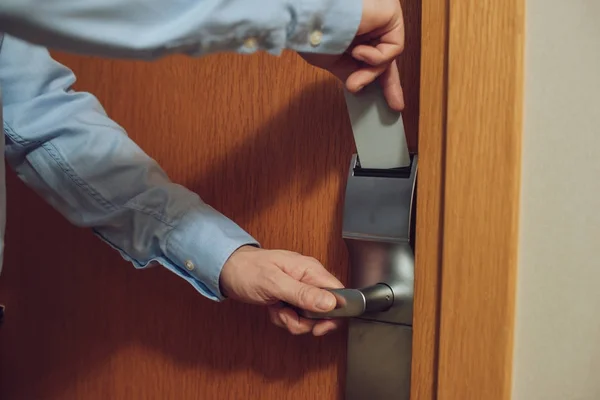 Cropped shot of man inserting card into electronic lock in hotel — Stock Photo