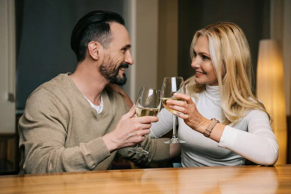 Happy mature couple drinking wine and smiling each other in hotel restaurant — Stock Photo