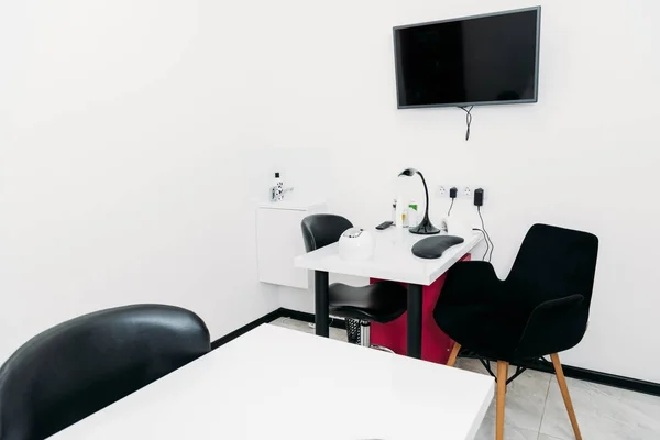 Empty manicure salon with tables and chairs — Stock Photo