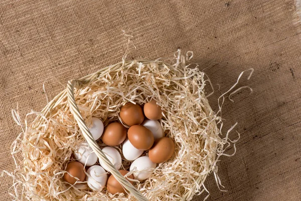 Chicken eggs in basket — Stock Photo, Image