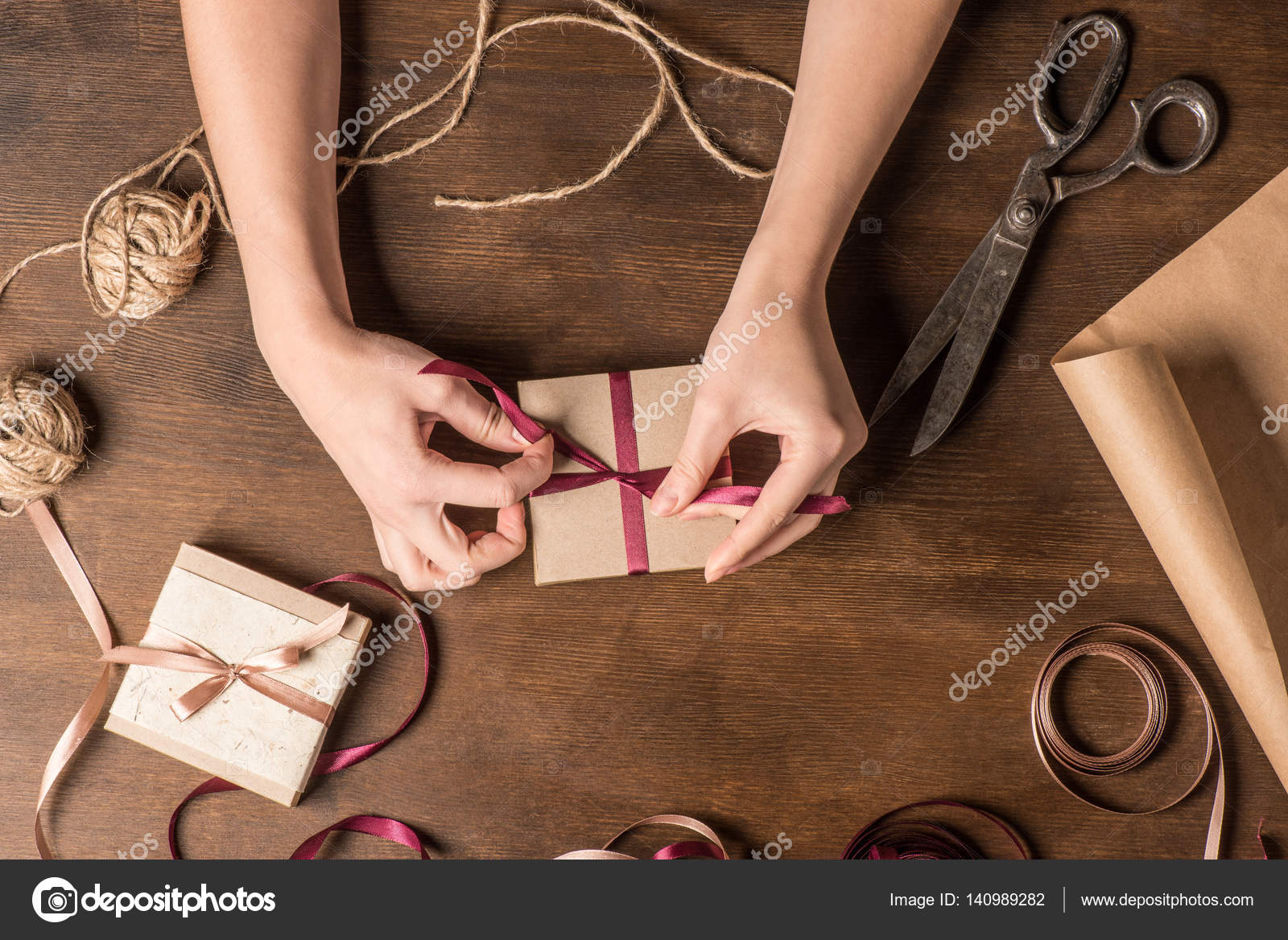 Hands tying ribbon on gift — Stock Photo © AndrewBedrov 140989282