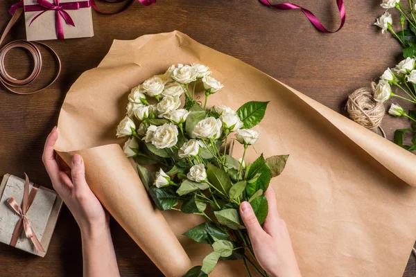 White roses in hands — Stock Photo