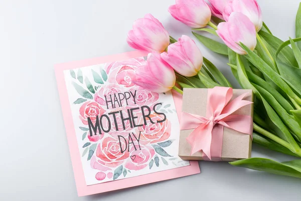 Tulips, postcard and gift — Stock Photo
