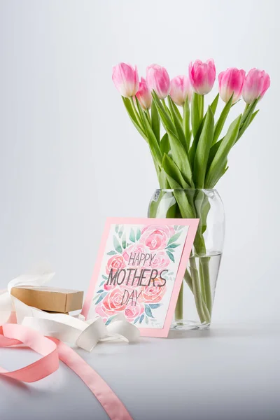 Tulips, postcard and gift — Stock Photo