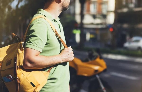 man holding in hands backpack and map