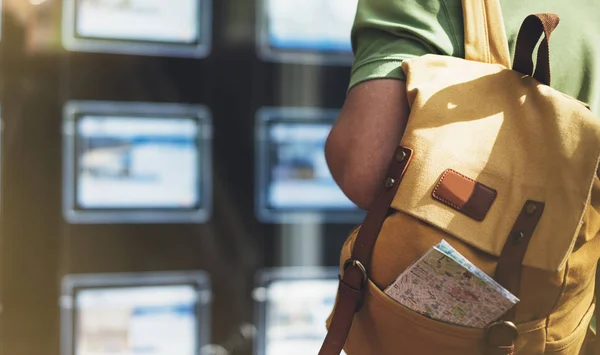 man with backpack and map looking ad promo poster hotel