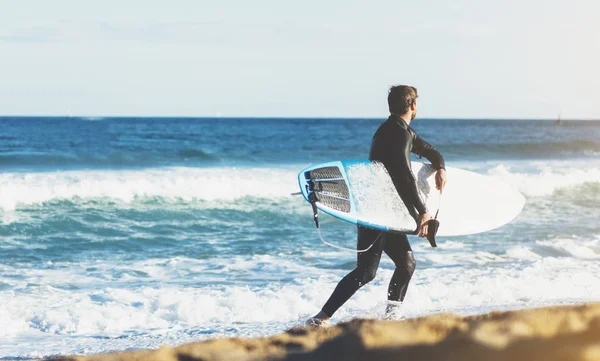 Surfer man holding surfboard